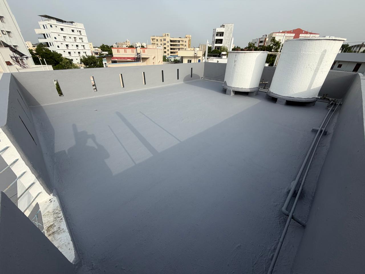 Same terrace fully coated in smooth grey elastomeric waterproofing including parapets