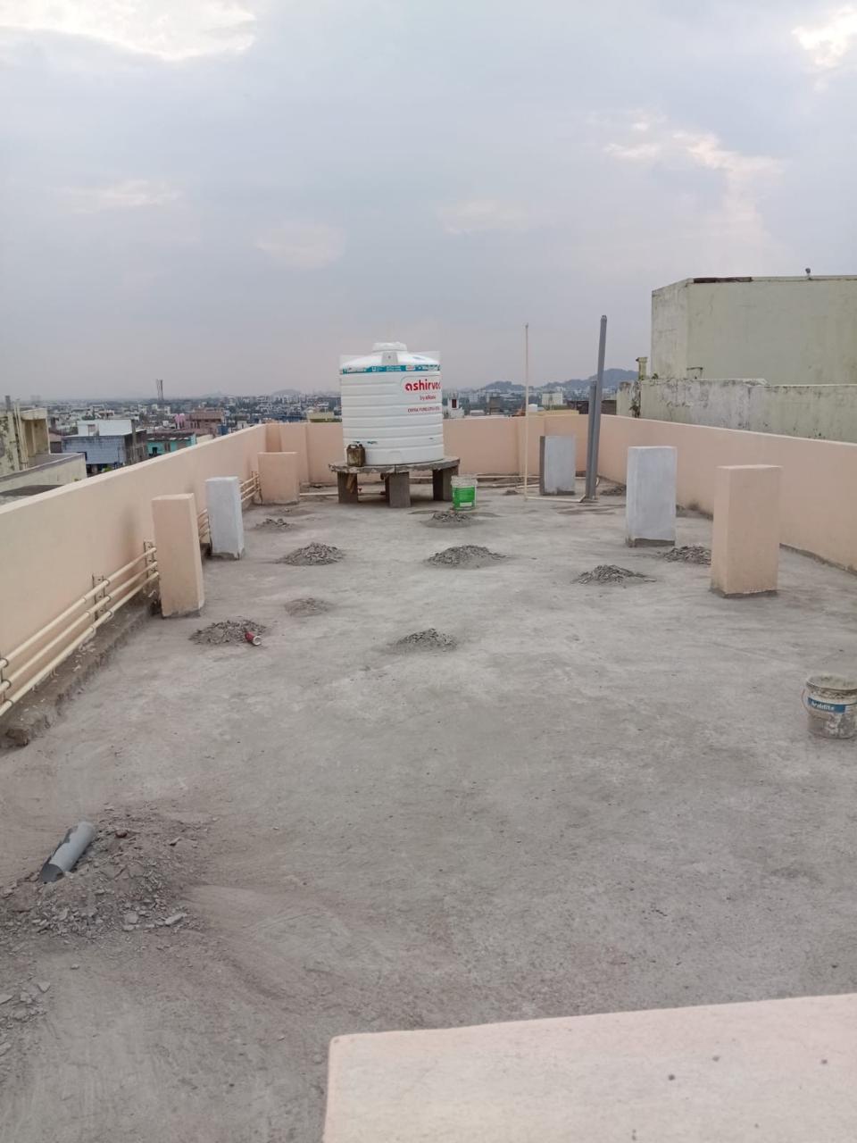 Bare cracked cement terrace with debris before waterproofing in Hanamkonda