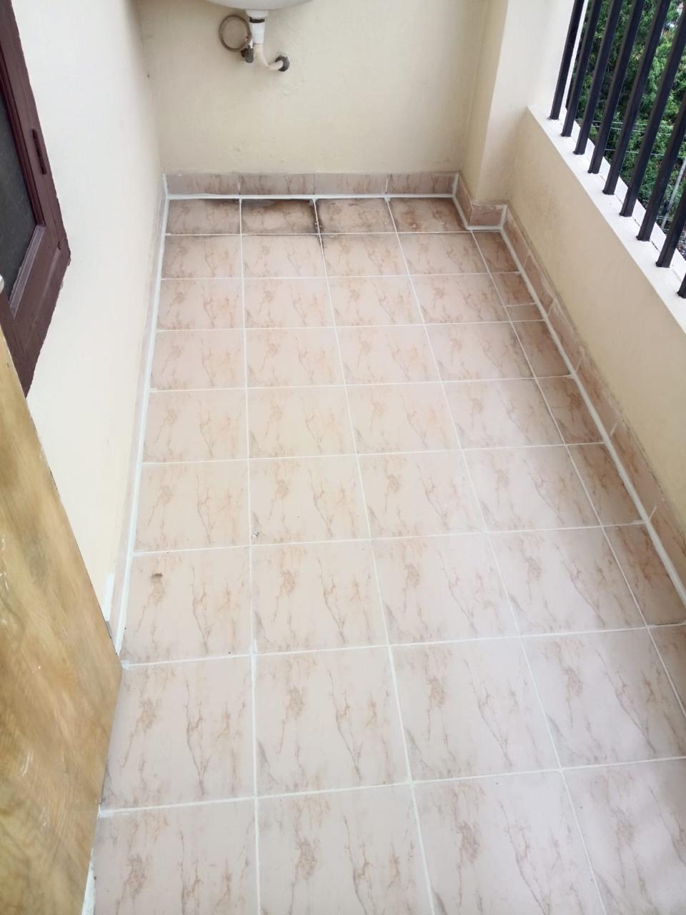 Same balcony after grout sealing with clean white waterproof joints