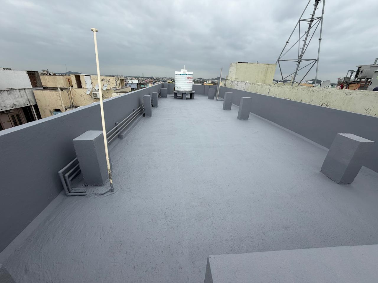 Same terrace after grey elastomeric waterproof coating with sealed parapet walls